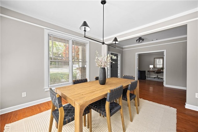 dining room featuring wood finished floors and baseboards