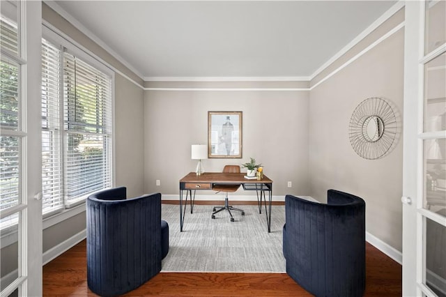 office space with ornamental molding, wood finished floors, and baseboards