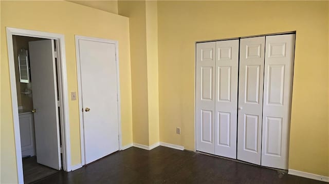 unfurnished bedroom featuring a closet and dark hardwood / wood-style floors