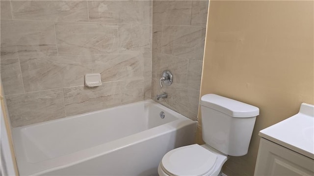 full bathroom with vanity, tiled shower / bath combo, and toilet