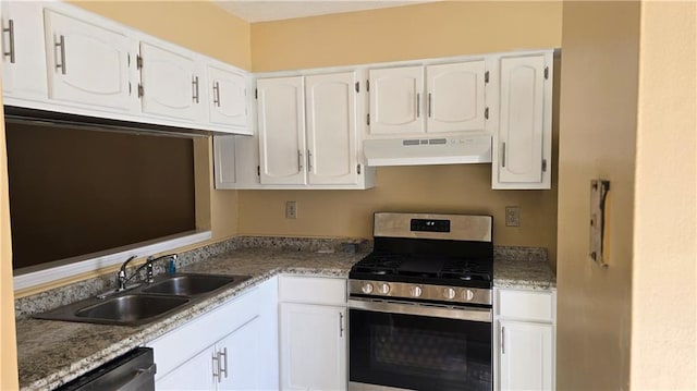 kitchen with white cabinets, dark stone countertops, stainless steel appliances, and sink