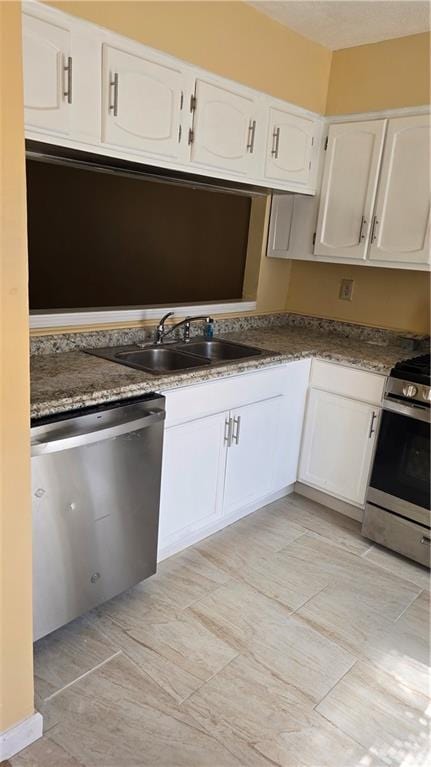 kitchen featuring white cabinets, stainless steel appliances, and sink