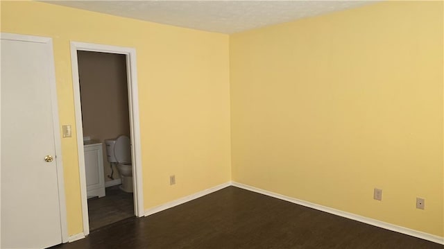 spare room featuring dark hardwood / wood-style floors