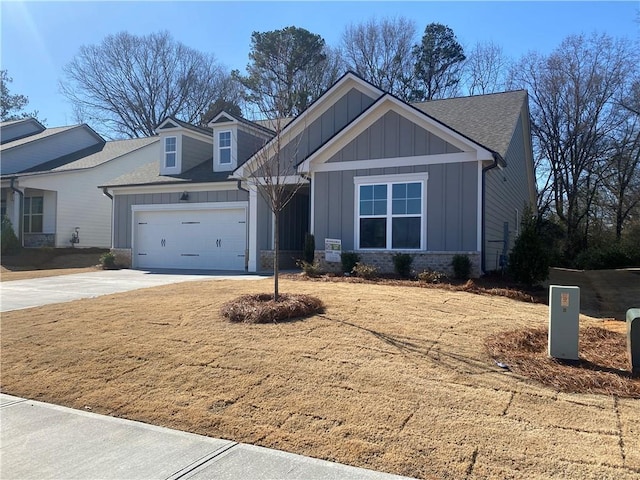 view of front of property featuring a garage, board and batten siding, concrete driveway, and a shingled roof