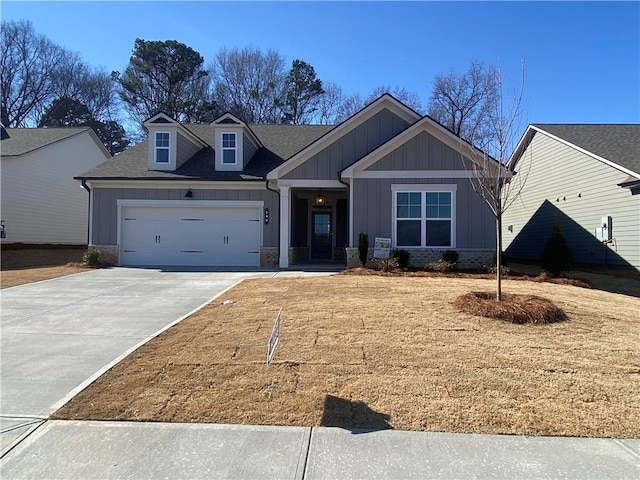 craftsman-style home with board and batten siding, concrete driveway, a shingled roof, a garage, and brick siding