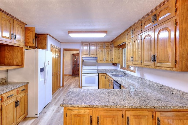 kitchen featuring sink, kitchen peninsula, white appliances, a textured ceiling, and light wood-type flooring