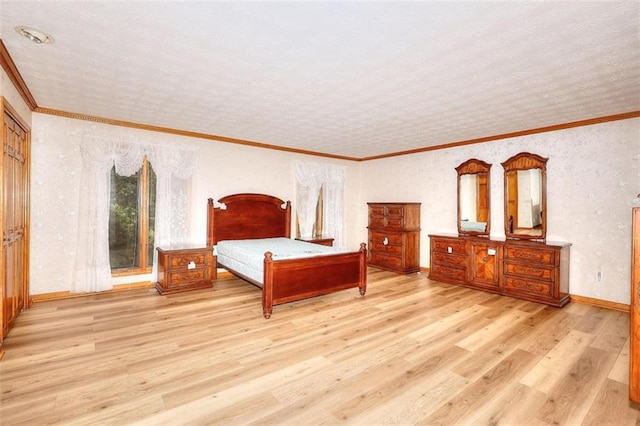 bedroom featuring ornamental molding, light hardwood / wood-style floors, and a textured ceiling