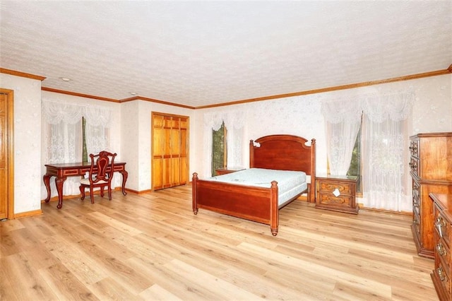 bedroom featuring a textured ceiling, ornamental molding, and light hardwood / wood-style flooring