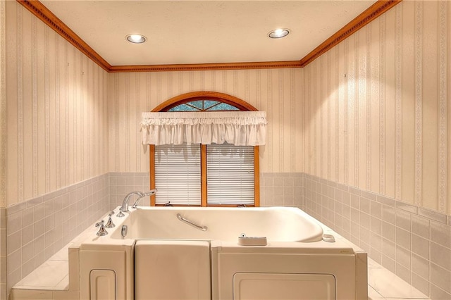 bathroom with a tub to relax in and crown molding