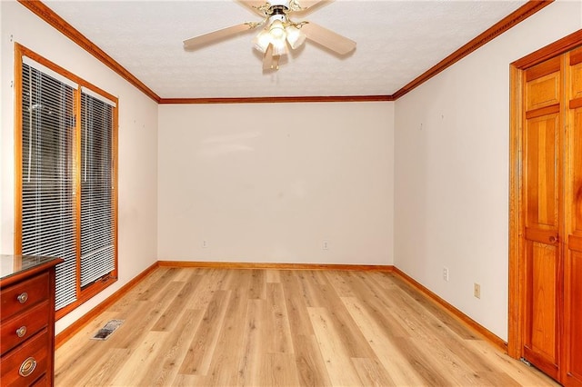 unfurnished bedroom featuring ceiling fan, light wood-type flooring, and ornamental molding