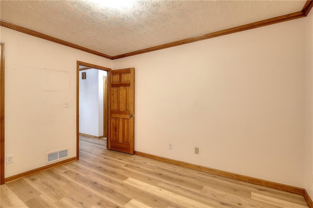 unfurnished room featuring light wood-type flooring, a textured ceiling, and ornamental molding