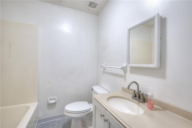 bathroom featuring vanity, toilet, and tile patterned floors