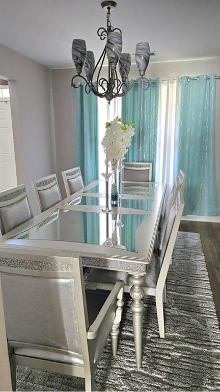 dining room with a chandelier and wood finished floors