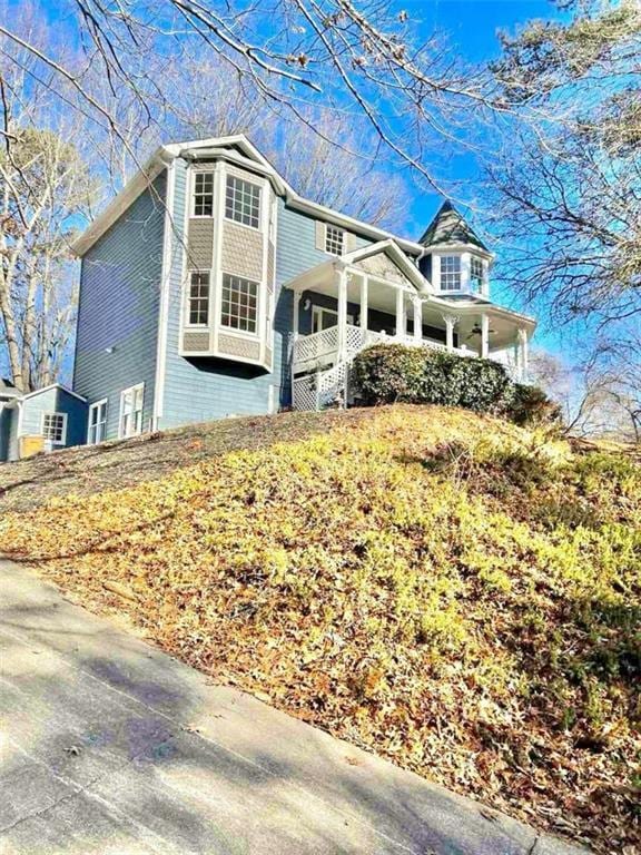 view of side of home with covered porch