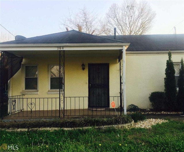 264 Taft St, Atlanta, GA 30315 - view of front of house featuring stucco siding and a shingled roof
