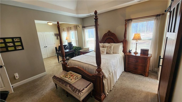 bedroom with light carpet and baseboards