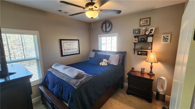 bedroom featuring carpet flooring, ceiling fan, visible vents, and baseboards