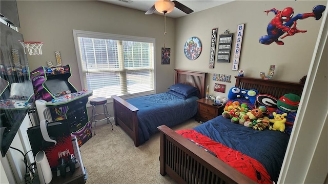 carpeted bedroom featuring a ceiling fan and visible vents