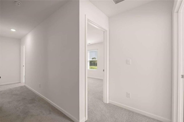 hallway with light colored carpet