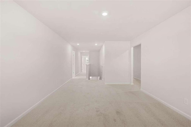 unfurnished room featuring light carpet