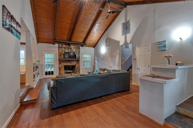 living room with dark wood-type flooring, high vaulted ceiling, and wooden ceiling