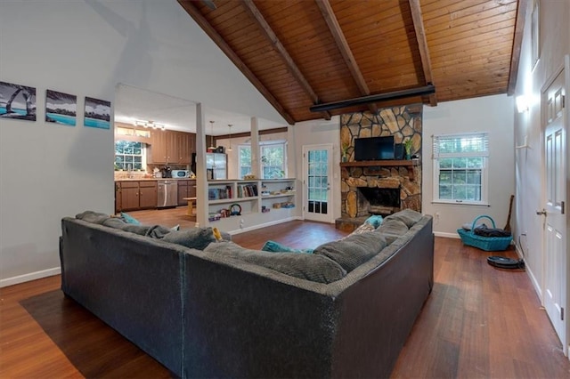 living room with a stone fireplace, wood ceiling, dark hardwood / wood-style floors, and high vaulted ceiling