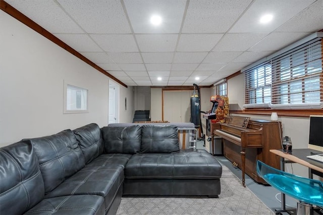 living room featuring ornamental molding and a drop ceiling