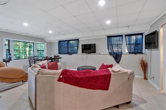 tiled living room featuring a drop ceiling