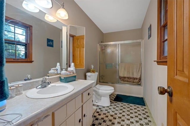 full bathroom featuring bath / shower combo with glass door, vanity, and toilet