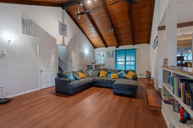 living room featuring ceiling fan, beamed ceiling, hardwood / wood-style flooring, and a wealth of natural light