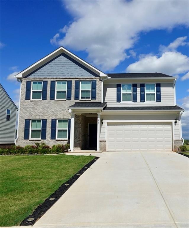 craftsman house featuring brick siding, driveway, an attached garage, and a front yard