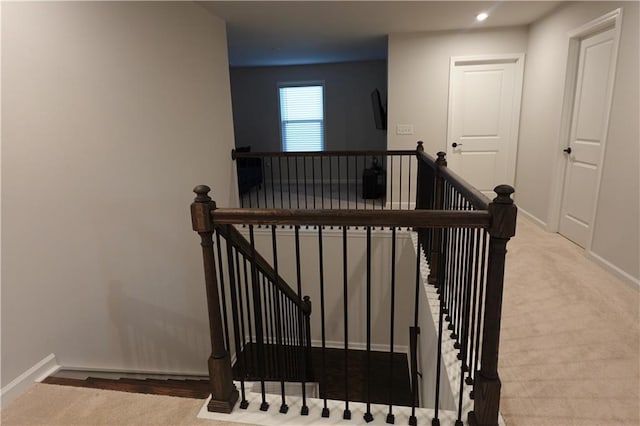 stairs featuring baseboards and carpet flooring