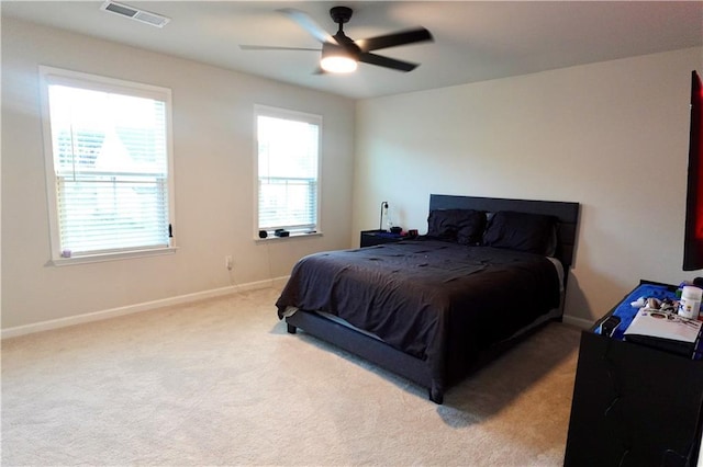 bedroom featuring visible vents, baseboards, carpet, and a ceiling fan