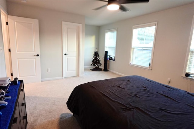 carpeted bedroom with a ceiling fan and baseboards