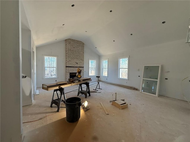 interior space featuring baseboard heating, a fireplace, and vaulted ceiling