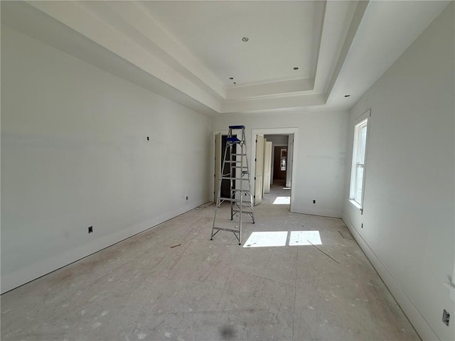 spare room featuring a raised ceiling