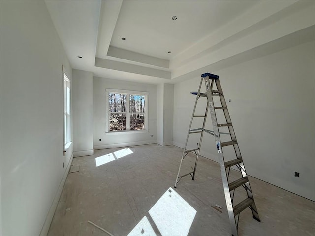 unfurnished room featuring a raised ceiling