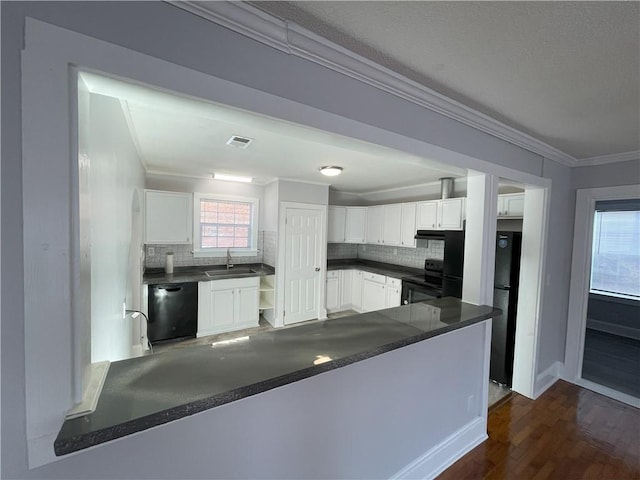 kitchen featuring kitchen peninsula, sink, white cabinets, ornamental molding, and black appliances