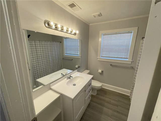 bathroom with curtained shower, wood-type flooring, ornamental molding, vanity, and toilet