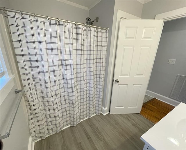 bathroom with vanity, hardwood / wood-style floors, crown molding, and a shower with shower curtain