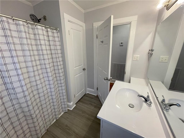 bathroom featuring vanity, crown molding, wood-type flooring, and curtained shower