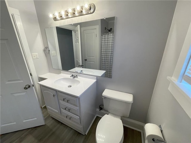 bathroom with vanity, toilet, a shower with shower curtain, and wood-type flooring