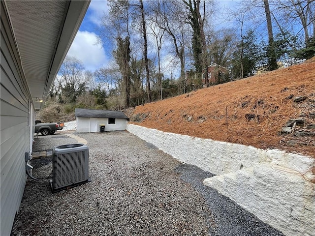 view of yard featuring cooling unit and an outdoor structure