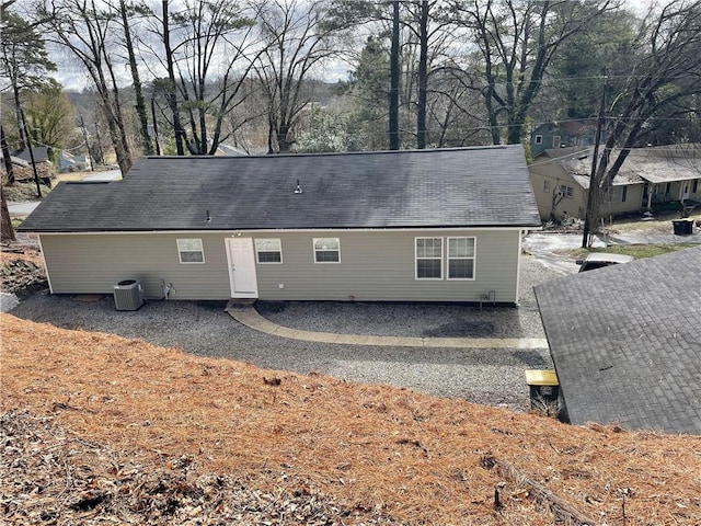 back of property featuring central AC