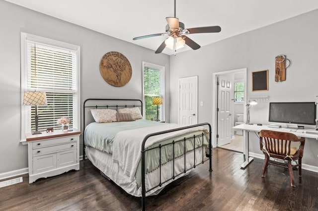 bedroom with ensuite bathroom, dark hardwood / wood-style flooring, and ceiling fan