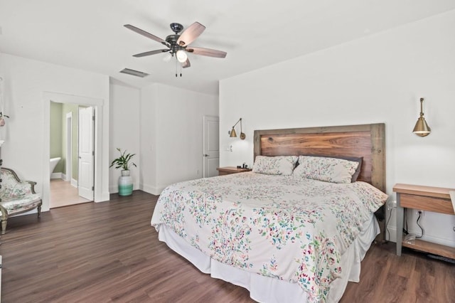 bedroom with ceiling fan, dark hardwood / wood-style flooring, and connected bathroom