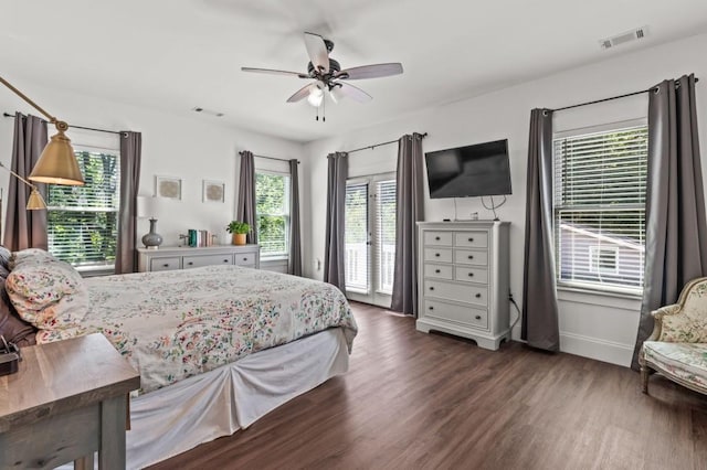 bedroom featuring ceiling fan, dark hardwood / wood-style flooring, and access to outside