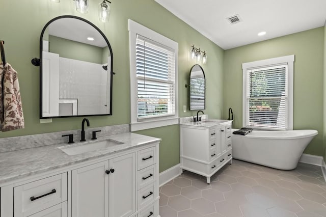 bathroom featuring double sink vanity, tile floors, and a bathing tub