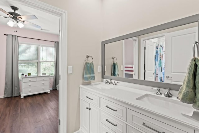 bathroom featuring ceiling fan, hardwood / wood-style floors, and double vanity