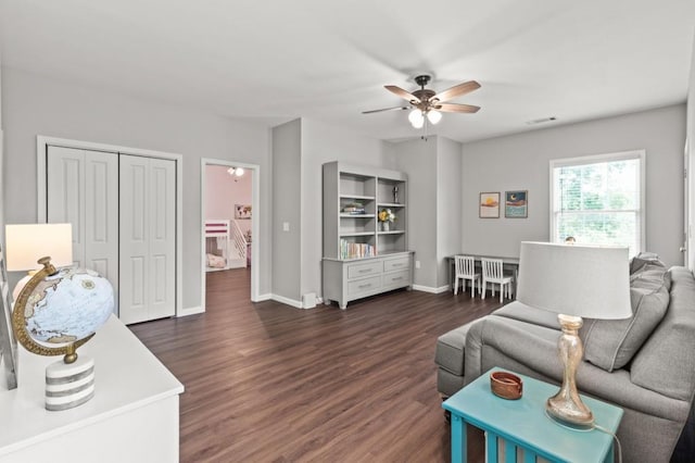 living room featuring dark hardwood / wood-style floors and ceiling fan